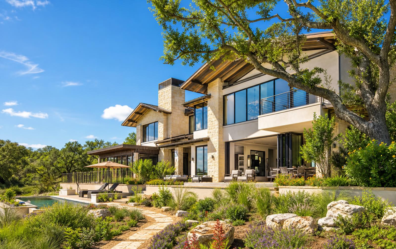 Bright sunny luxury Austin Hill Country estate with Fleetwood glass walls, limestone exterior, and pool terrace