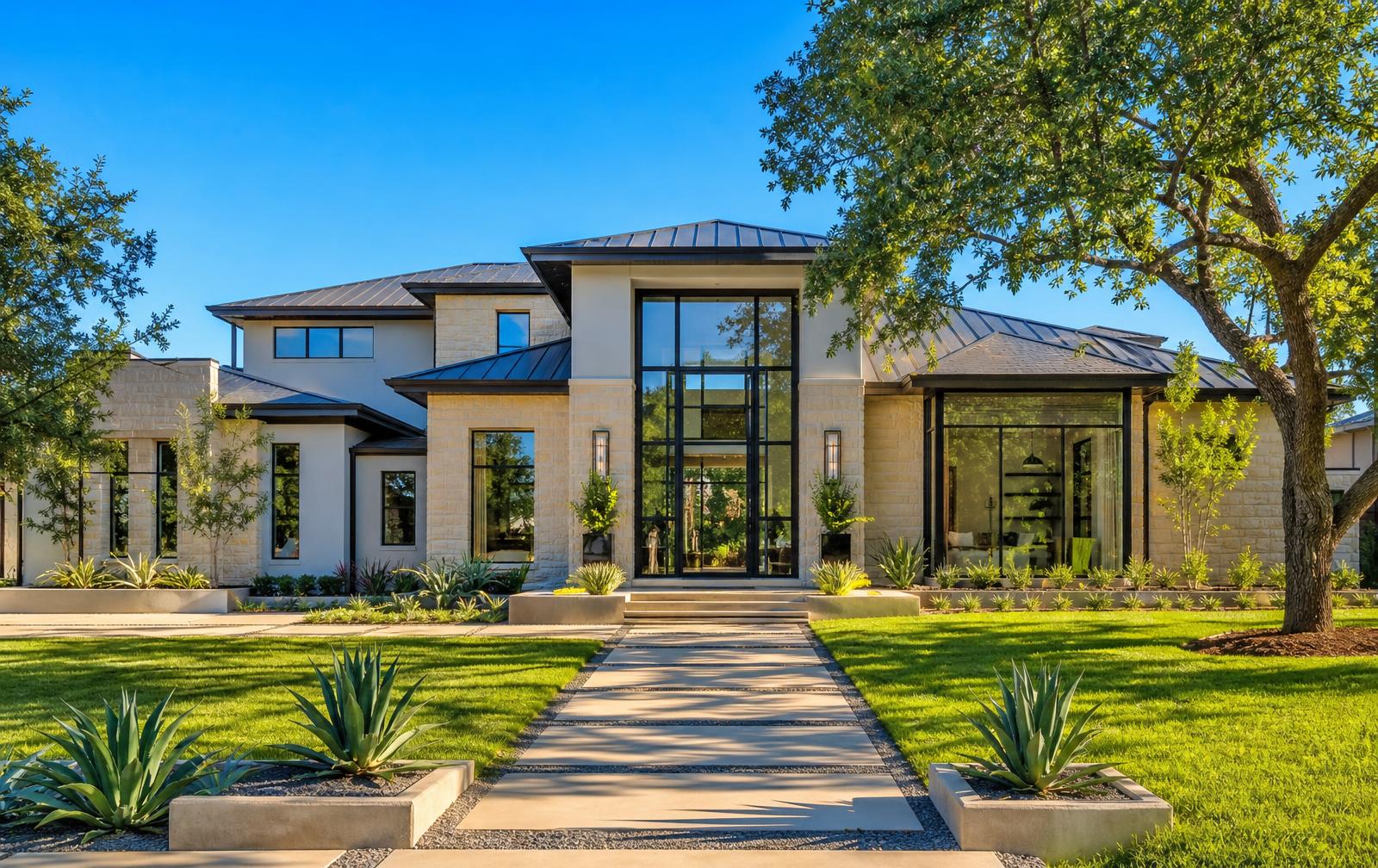 Bright sunny luxury Dallas estate with tall steel windows and glass entry surrounded by manicured landscaping