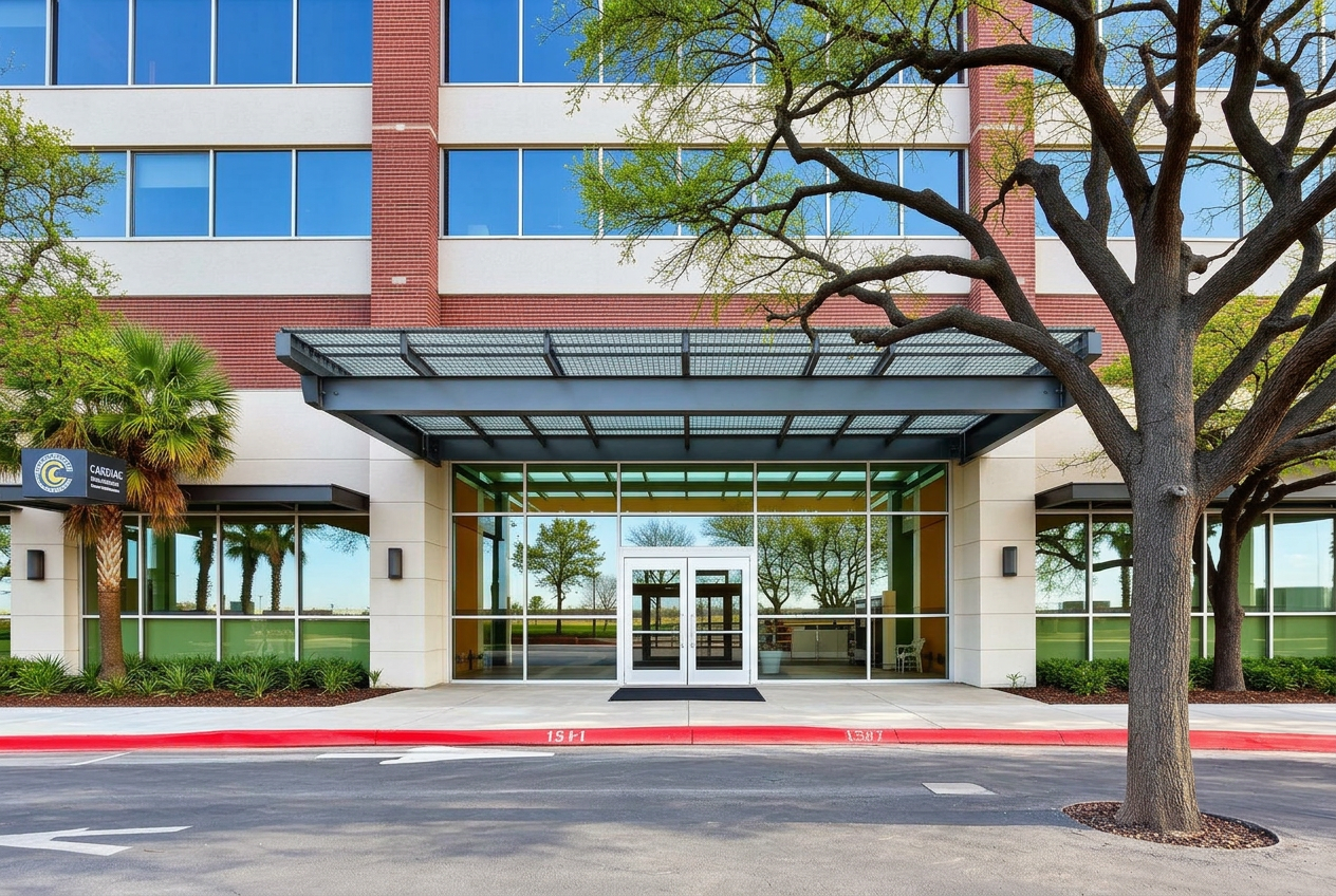 Modern San Antonio commercial office building entrance with large glass storefront and steel canopy