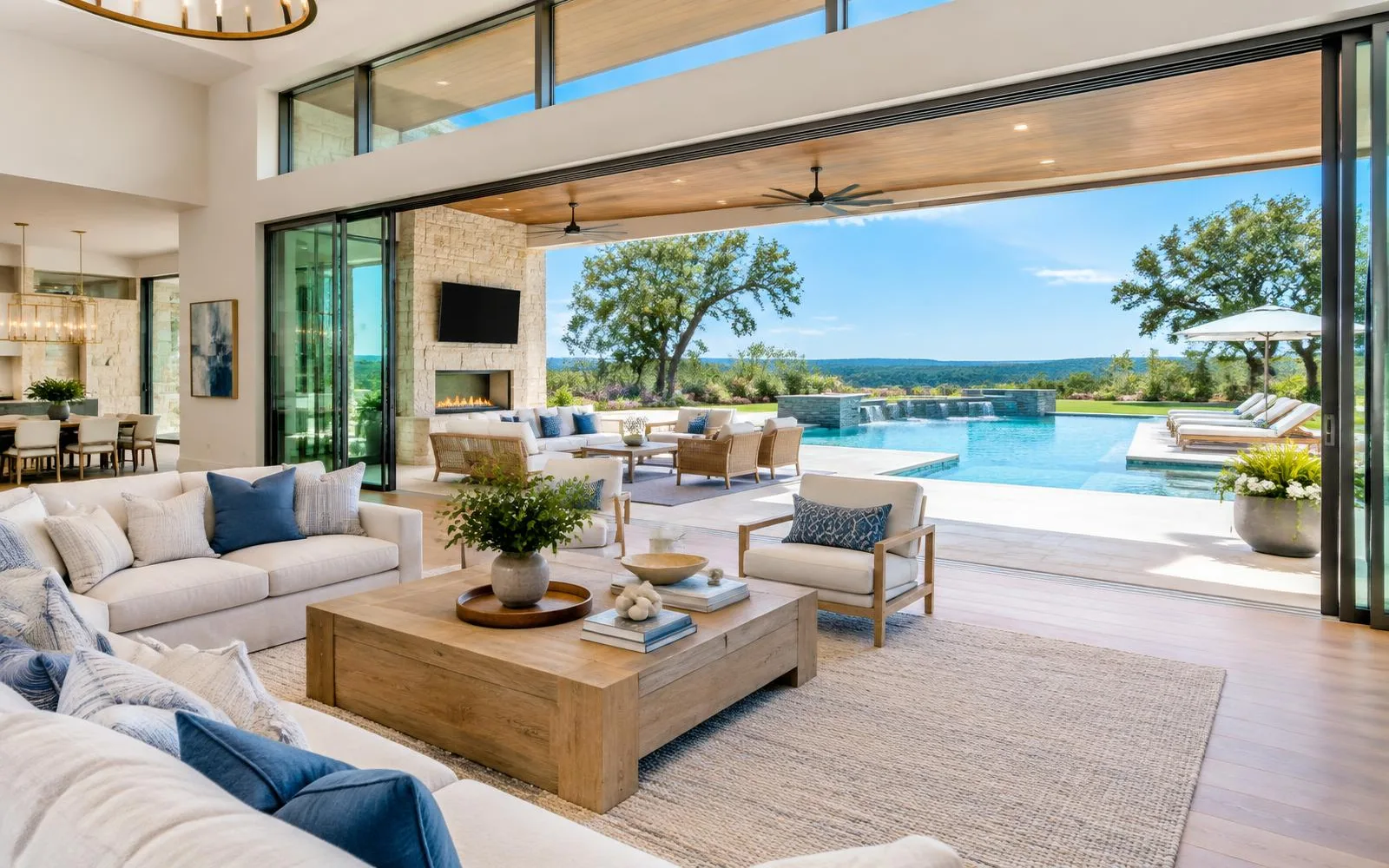 Luxury indoor-outdoor great room with oversized Fleetwood multi-slide doors open to a poolside patio in Texas