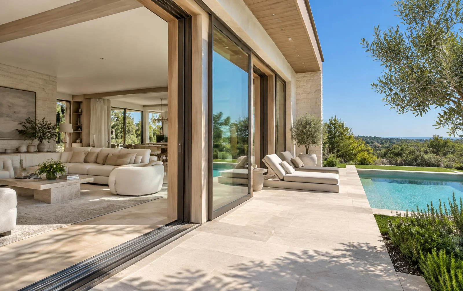 Luxury patio door inspiration connecting a light-filled living room with a poolside terrace